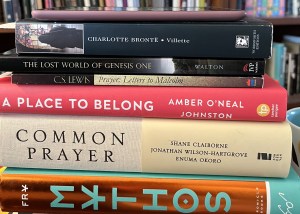 A stack of books with a kindle on top